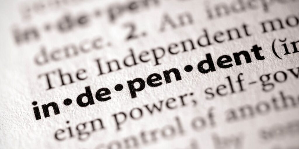 Close-up of the word 'independent' in a dictionary with phonetic pronunciation marks.
