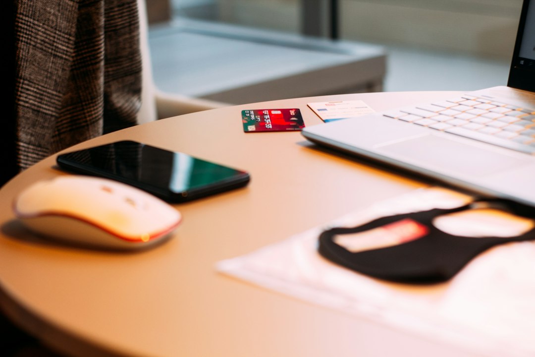 A clean flat lay of a calculator, house keys, and a pen on a modern desk, illustrating the process of comparing discount brokers and calculating commission savings.
